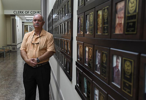 Carey Bolt, Laurens County Veterans Service Officer, poses for a photo in the Laurens County Courthouse Hall of Heroes.